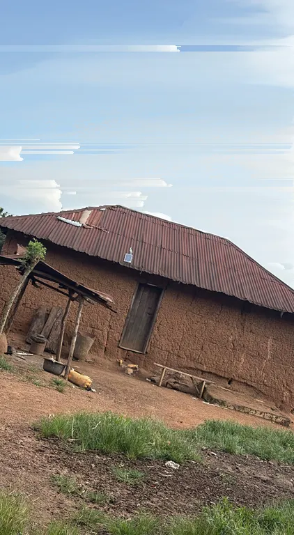 A house beneath a blue sky whose clouds have been sorted into long horizontal streaks.